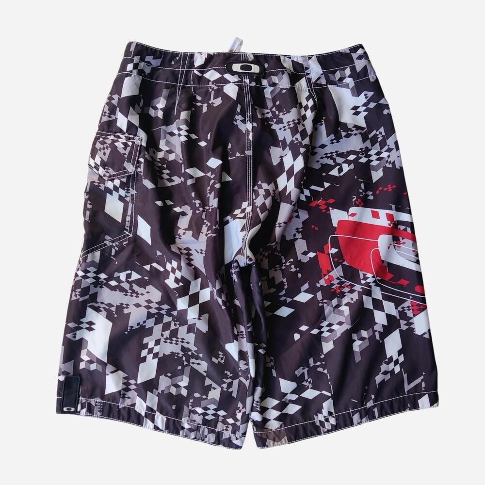 Y2K Oakley baggy board shorts with white and gray geometric pattern and red grap